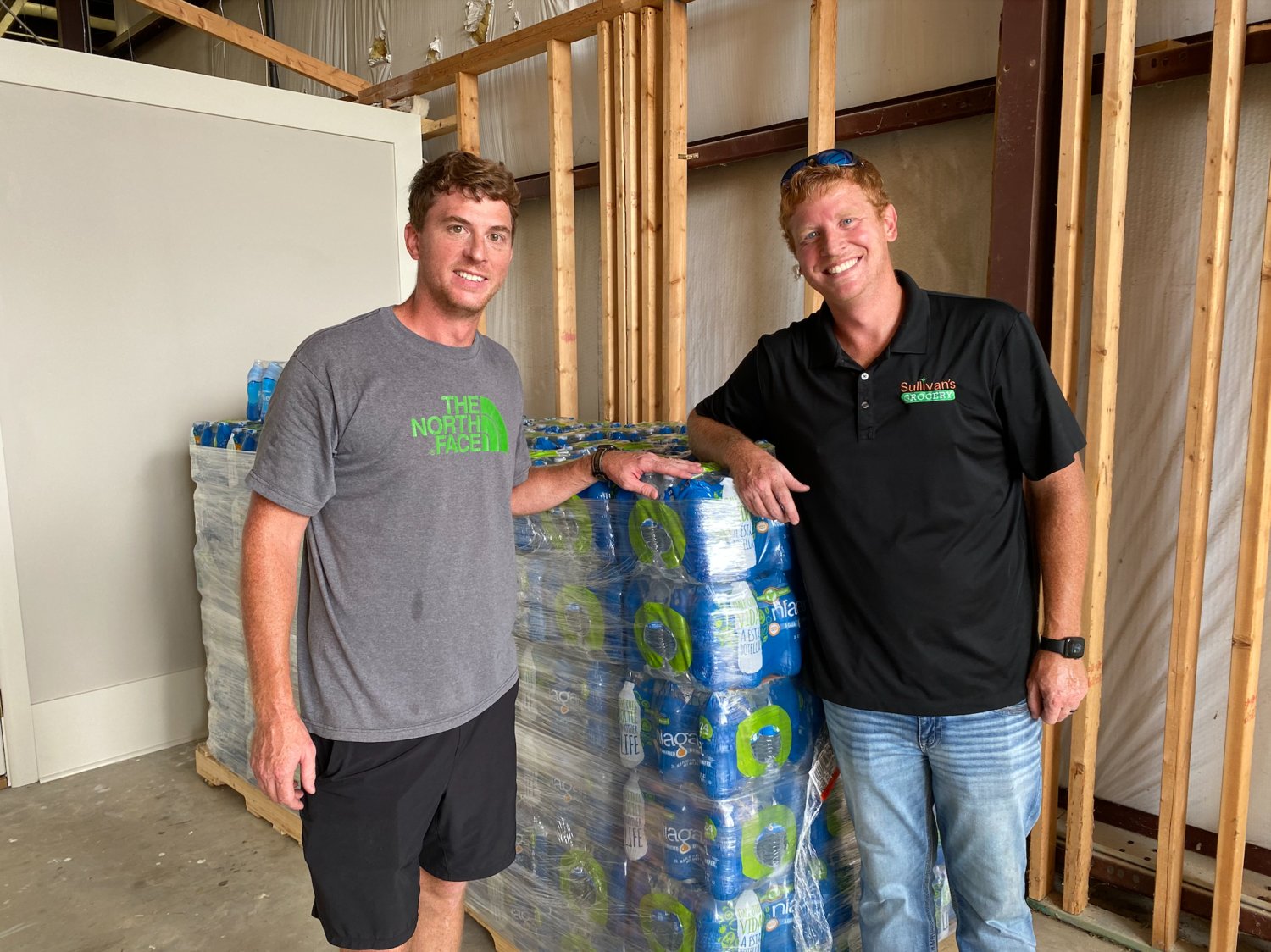 Parker Sullivan and Shawn Sullivan offload a pallet of water at Gluckstadt City Hall. The brothers, part of the newly-built Sullivan’s Grocery, are one of a number of businesses and individuals currently donating water to Jackson residents in need.